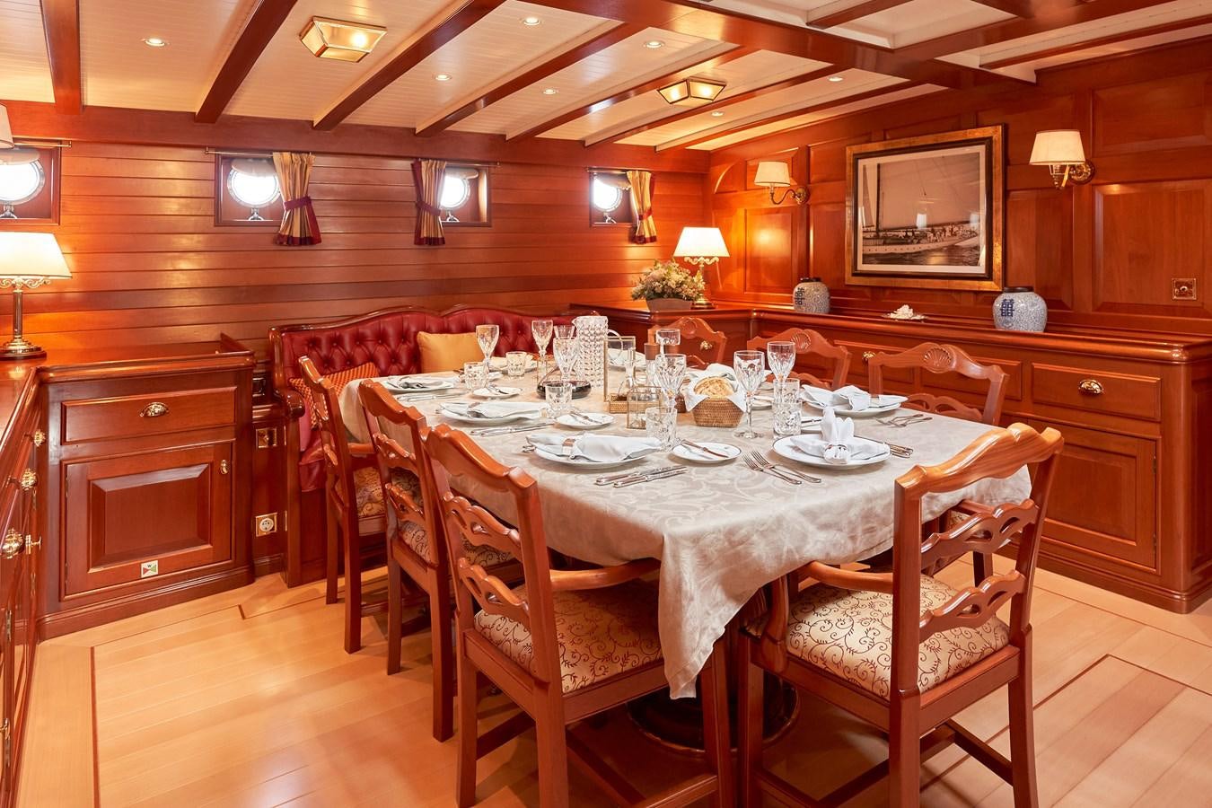 a dining room with a table set aboard ELENA OF LONDON Yacht for Sale