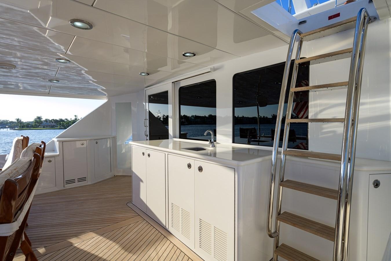 a white kitchen with a ladder aboard SAR Yacht for Sale