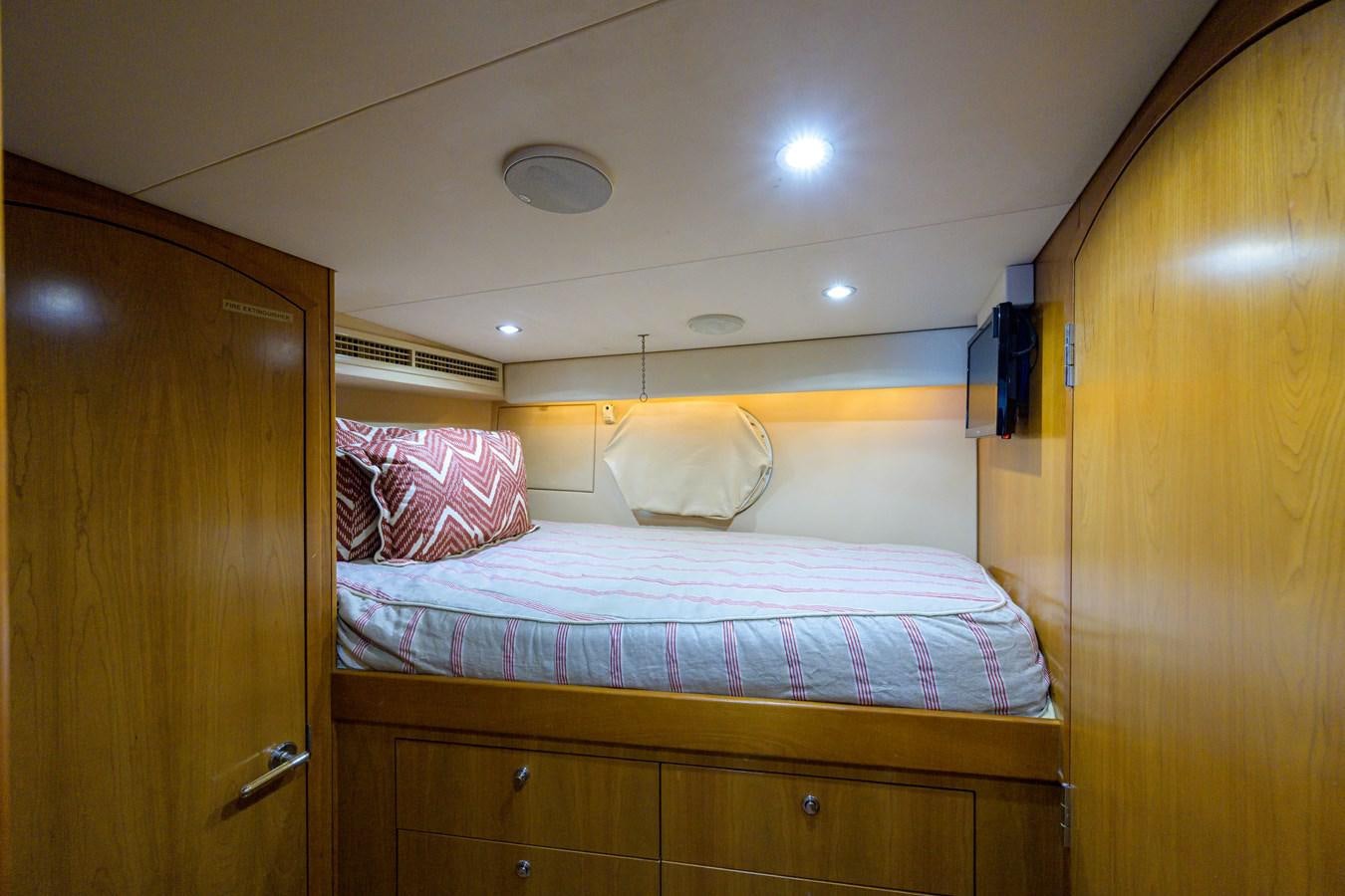a bedroom with a bed and a closet aboard SAR Yacht for Sale