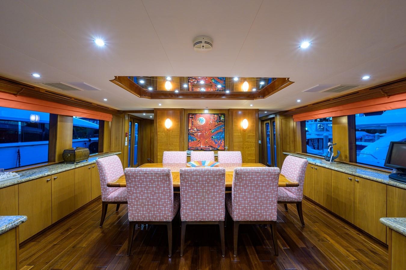 a large room with a table and chairs aboard SAR Yacht for Sale