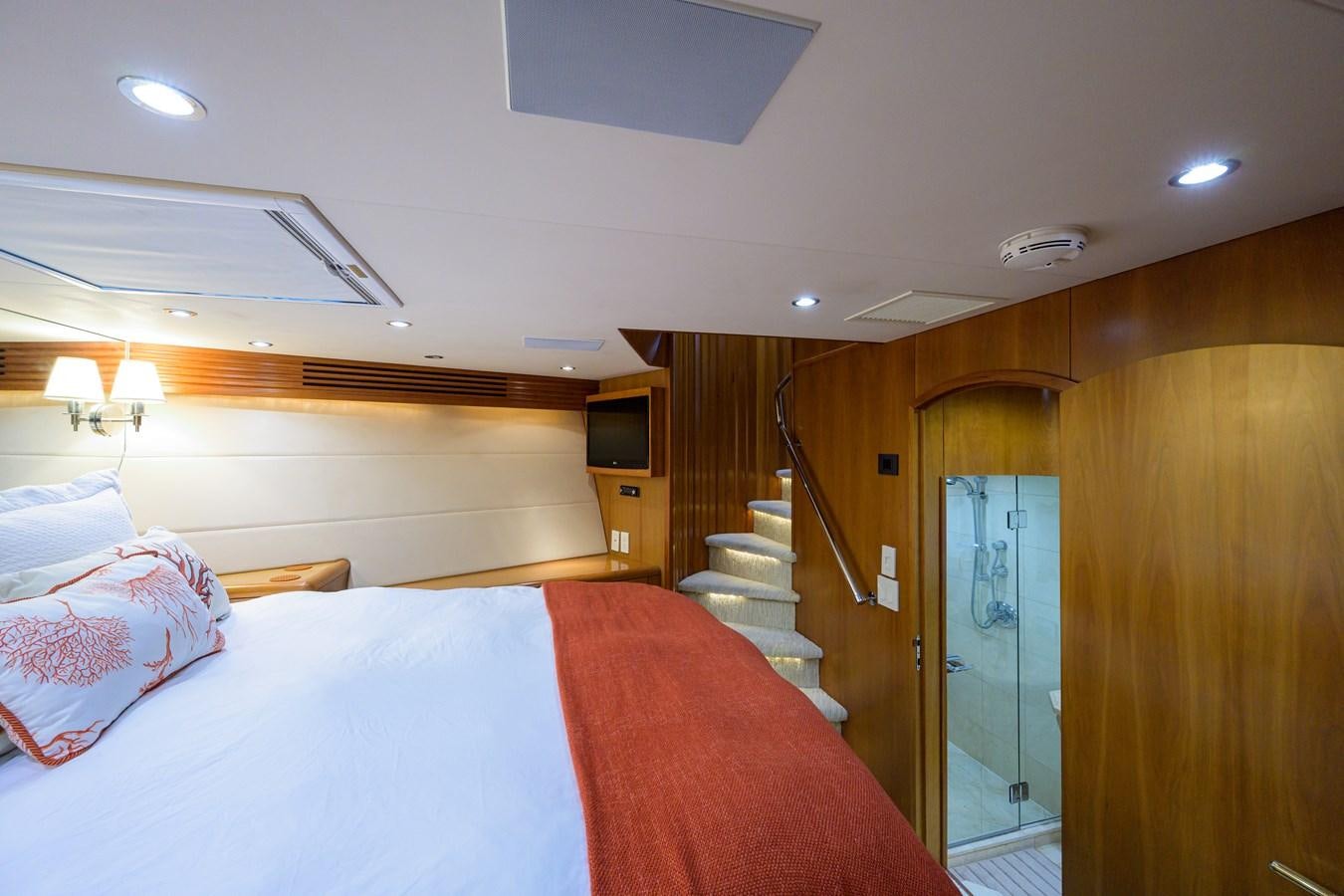 a bedroom with a bed and a staircase aboard SAR Yacht for Sale