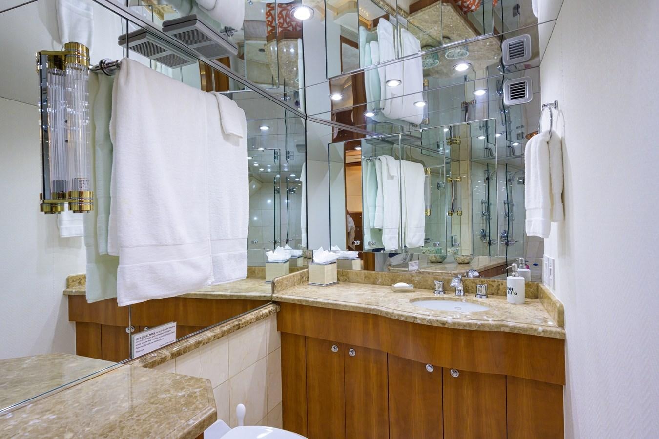 a bathroom with a sink and towels aboard SAR Yacht for Sale