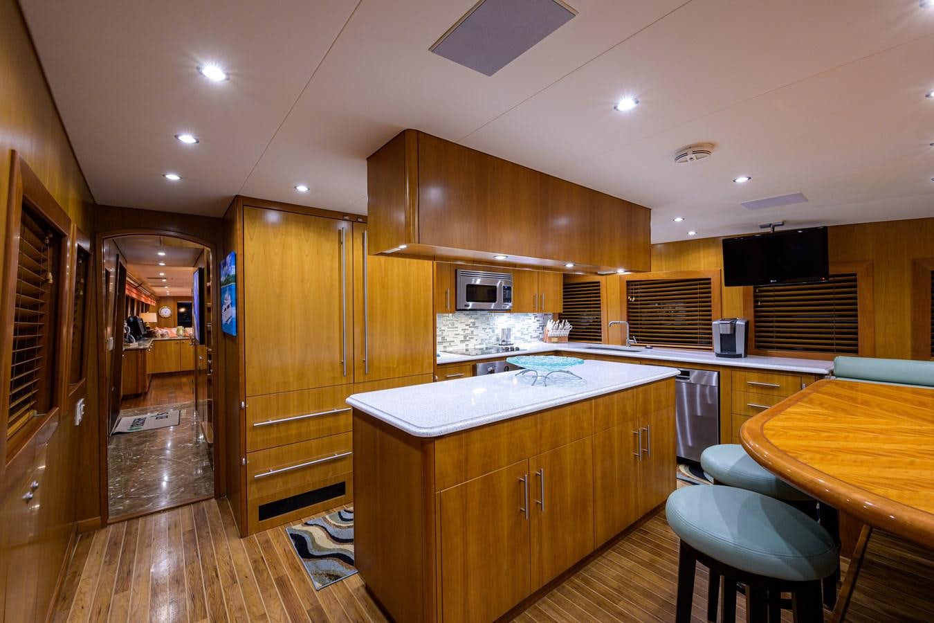 a kitchen with wooden cabinets aboard SAR Yacht for Sale