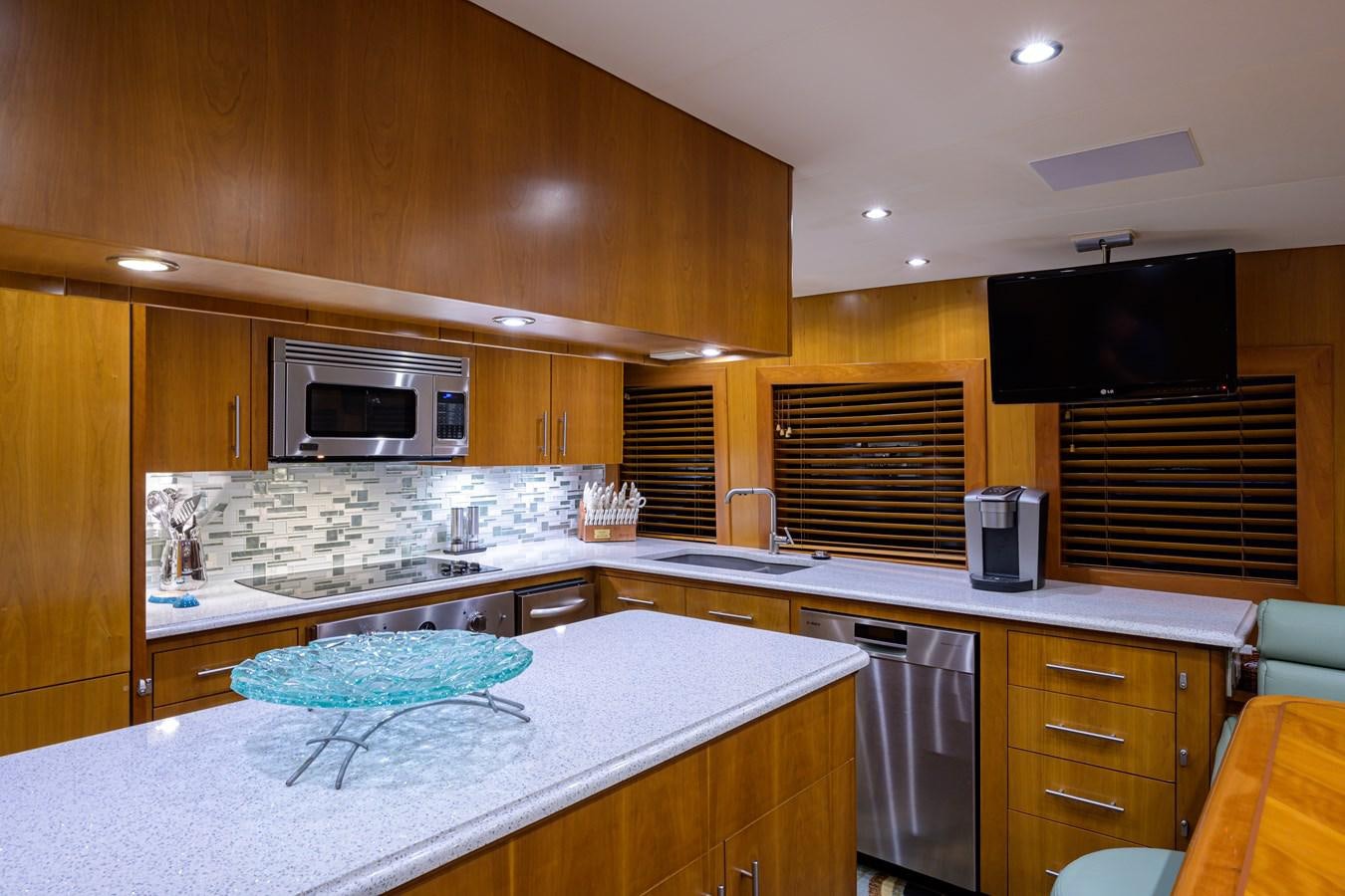 a kitchen with wooden cabinets aboard SAR Yacht for Sale