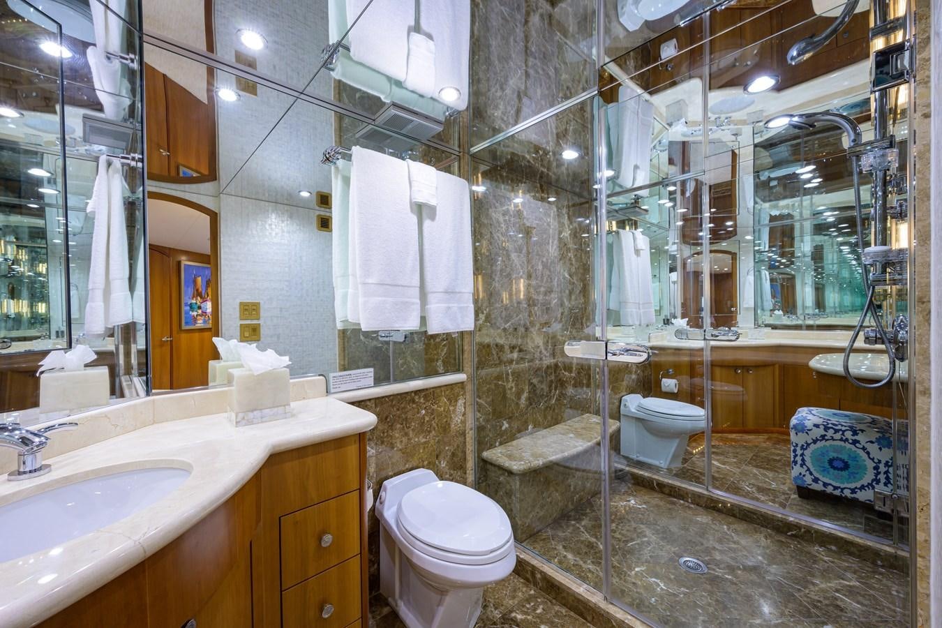 a bathroom with a glass shower aboard SAR Yacht for Sale