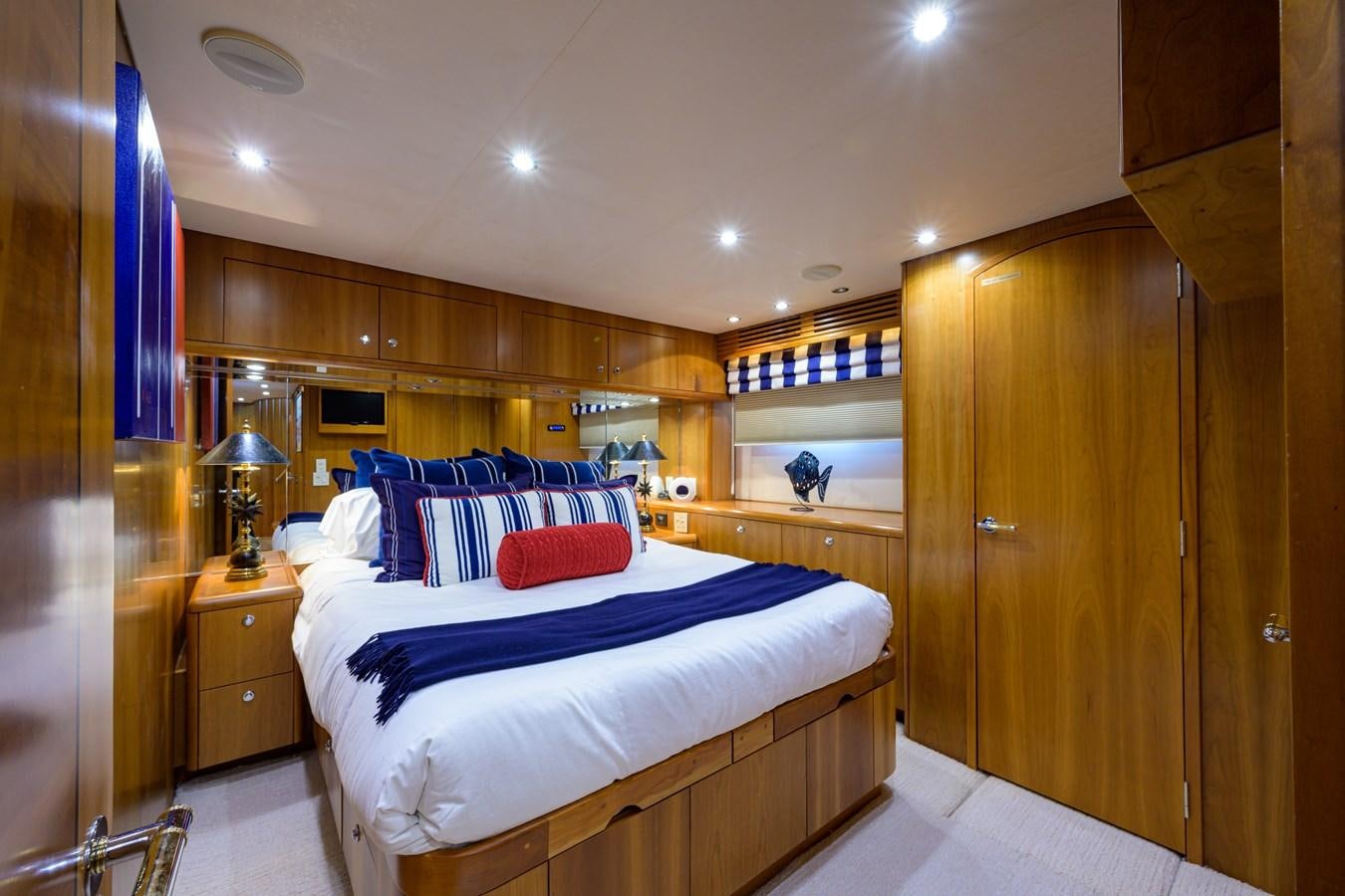 a bedroom with a bed and a closet aboard SAR Yacht for Sale