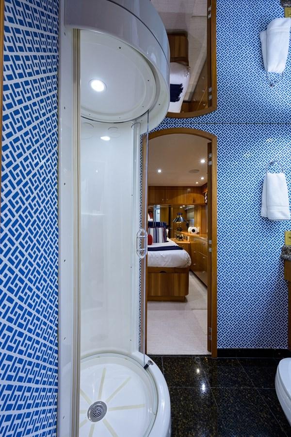 a bathroom with a glass shower aboard SAR Yacht for Sale