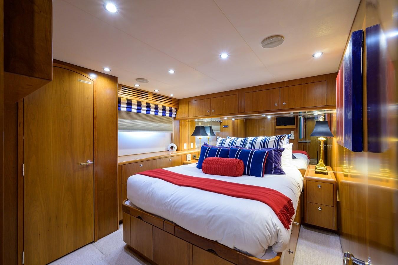 a bedroom with a bed and a desk aboard SAR Yacht for Sale