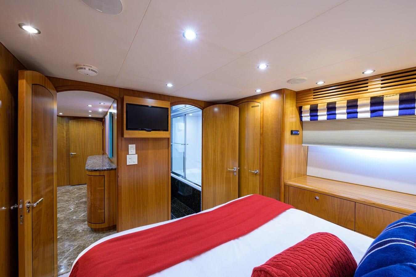 a bedroom with a bed and a closet aboard SAR Yacht for Sale