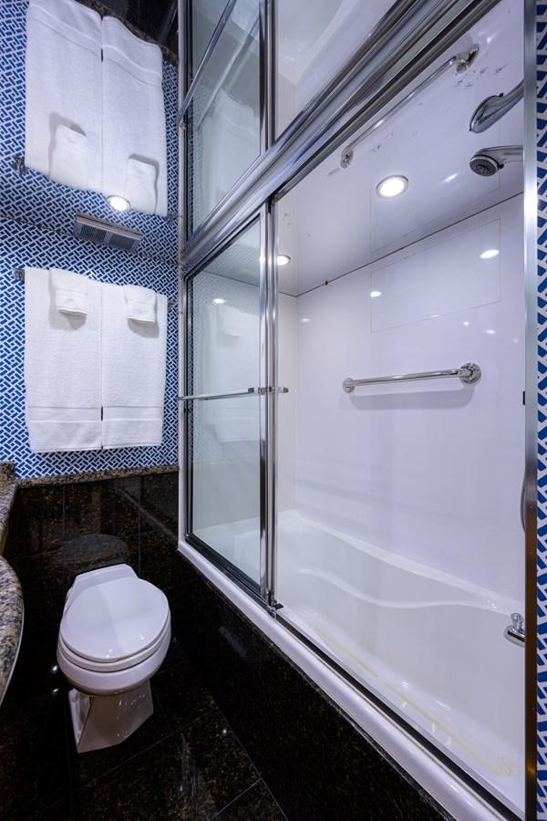 a bathroom with a glass shower aboard SAR Yacht for Sale