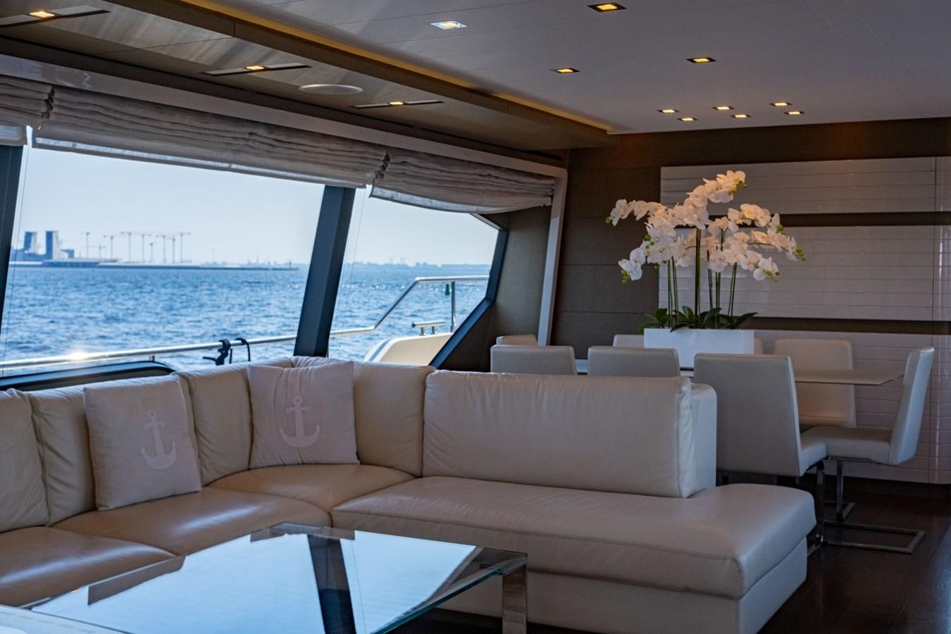 a living room with a large window aboard FERRETTI 870 Yacht for Sale