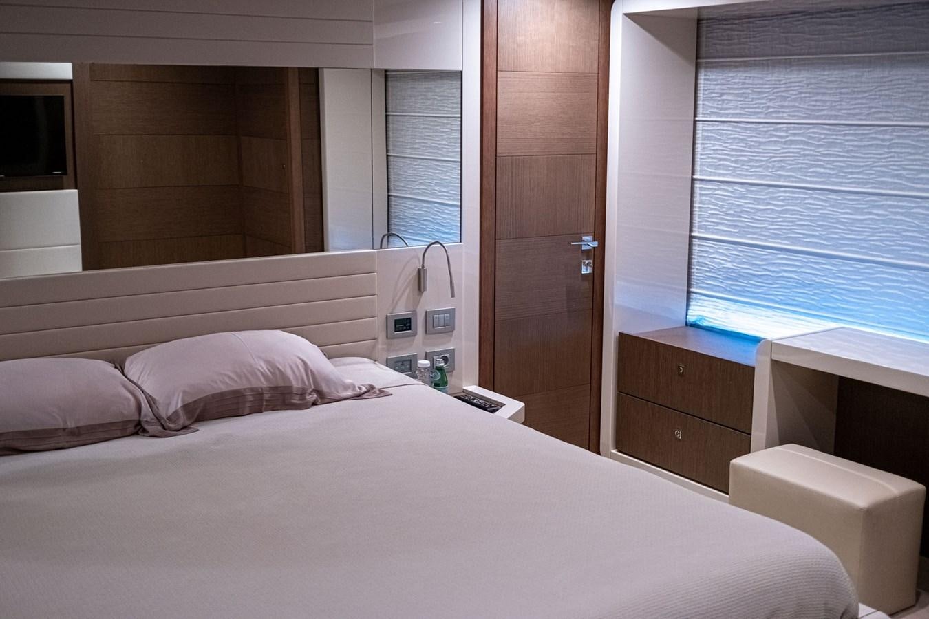 a bed with a white sheet aboard FERRETTI 870 Yacht for Sale