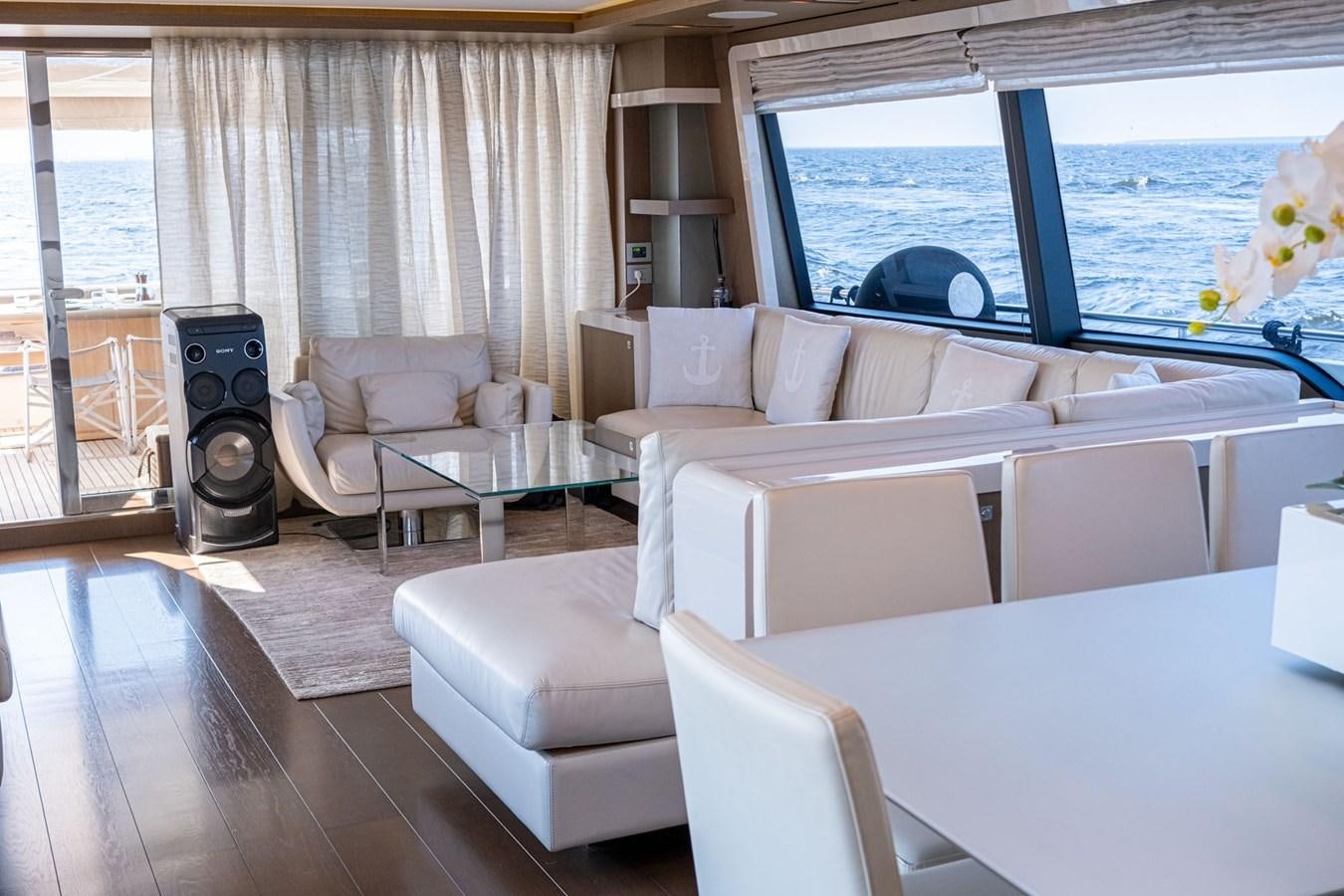 a living room with a large window aboard FERRETTI 870 Yacht for Sale