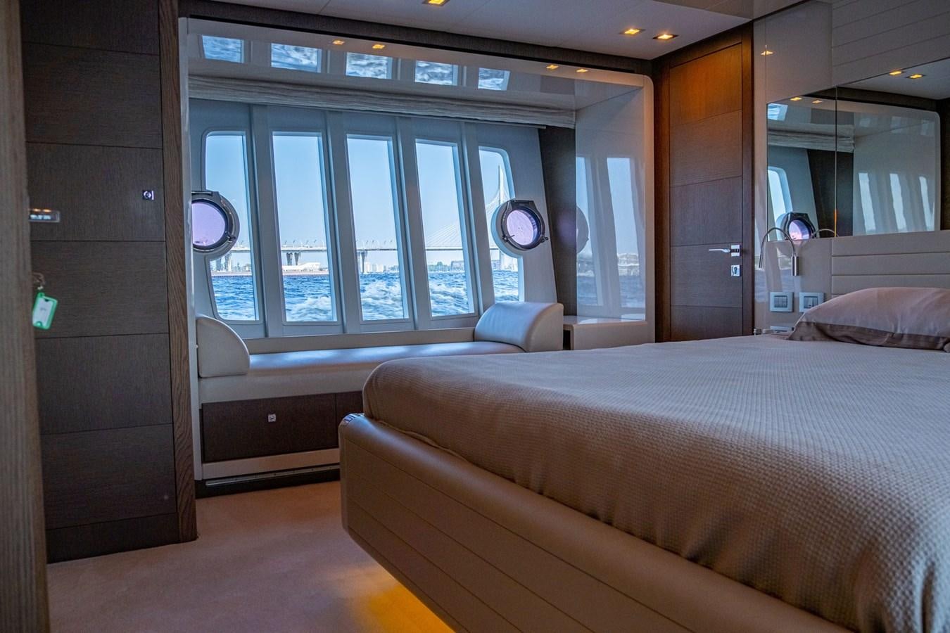 a room with a bed and a desk aboard FERRETTI 870 Yacht for Sale
