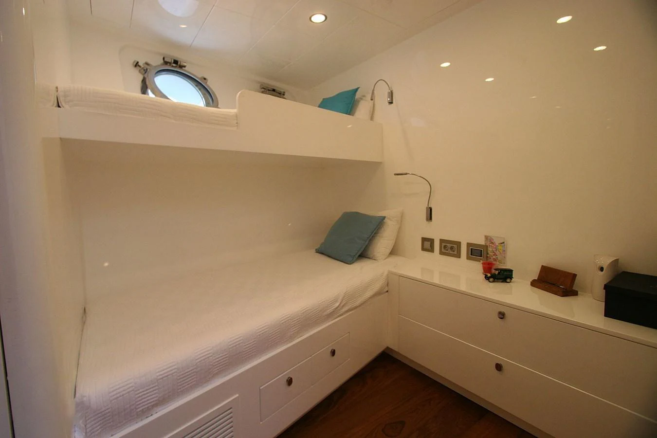 a room with a bed and a window aboard METEOR Yacht for Sale