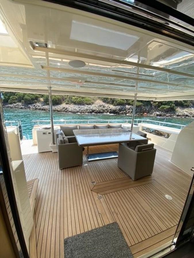 a room with a table and chairs aboard SELF Yacht for Sale