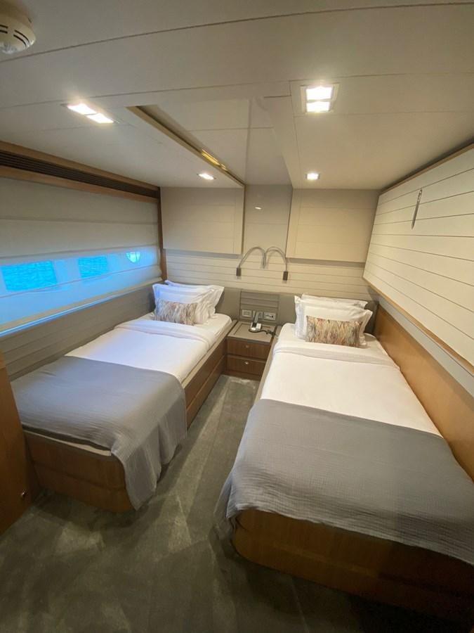 a room with a bed and a tv aboard SELF Yacht for Sale