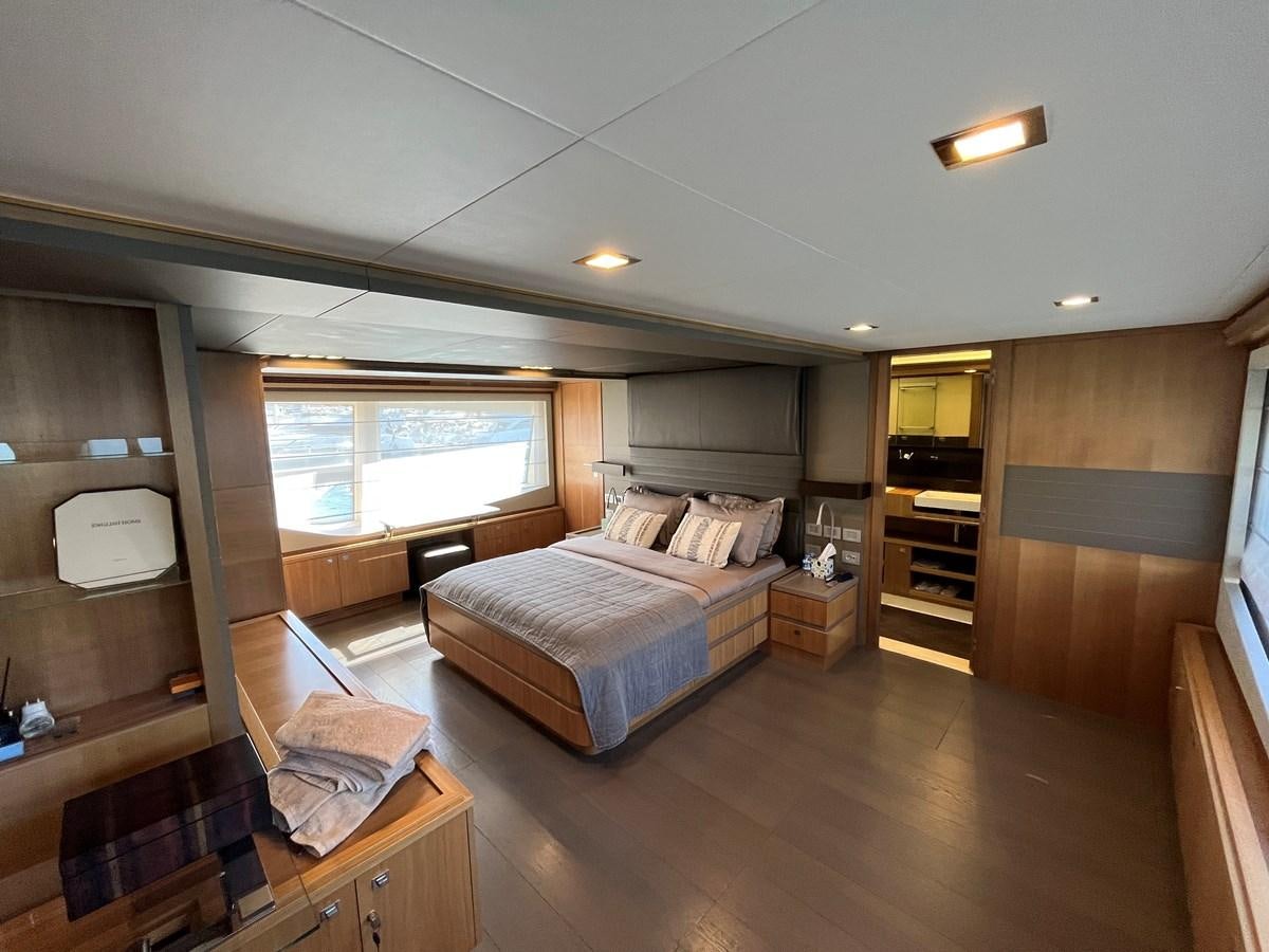 a bedroom with a bed and a tv aboard SELF Yacht for Sale
