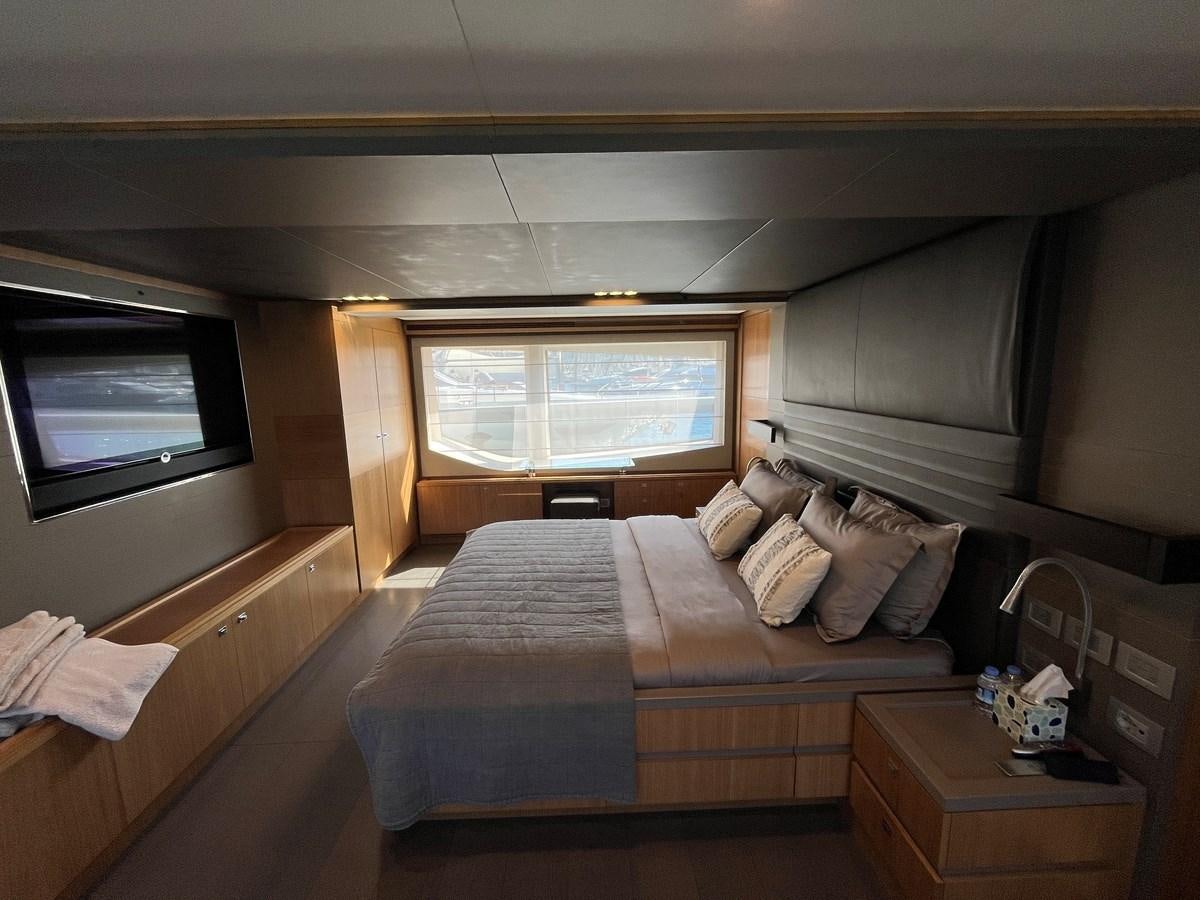 a bedroom with a bed and a tv aboard SELF Yacht for Sale
