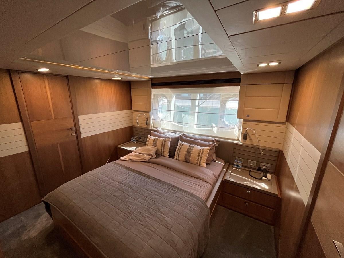 a room with a bed and a window aboard SELF Yacht for Sale