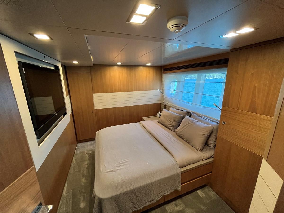 a room with a bed and a window aboard SELF Yacht for Sale