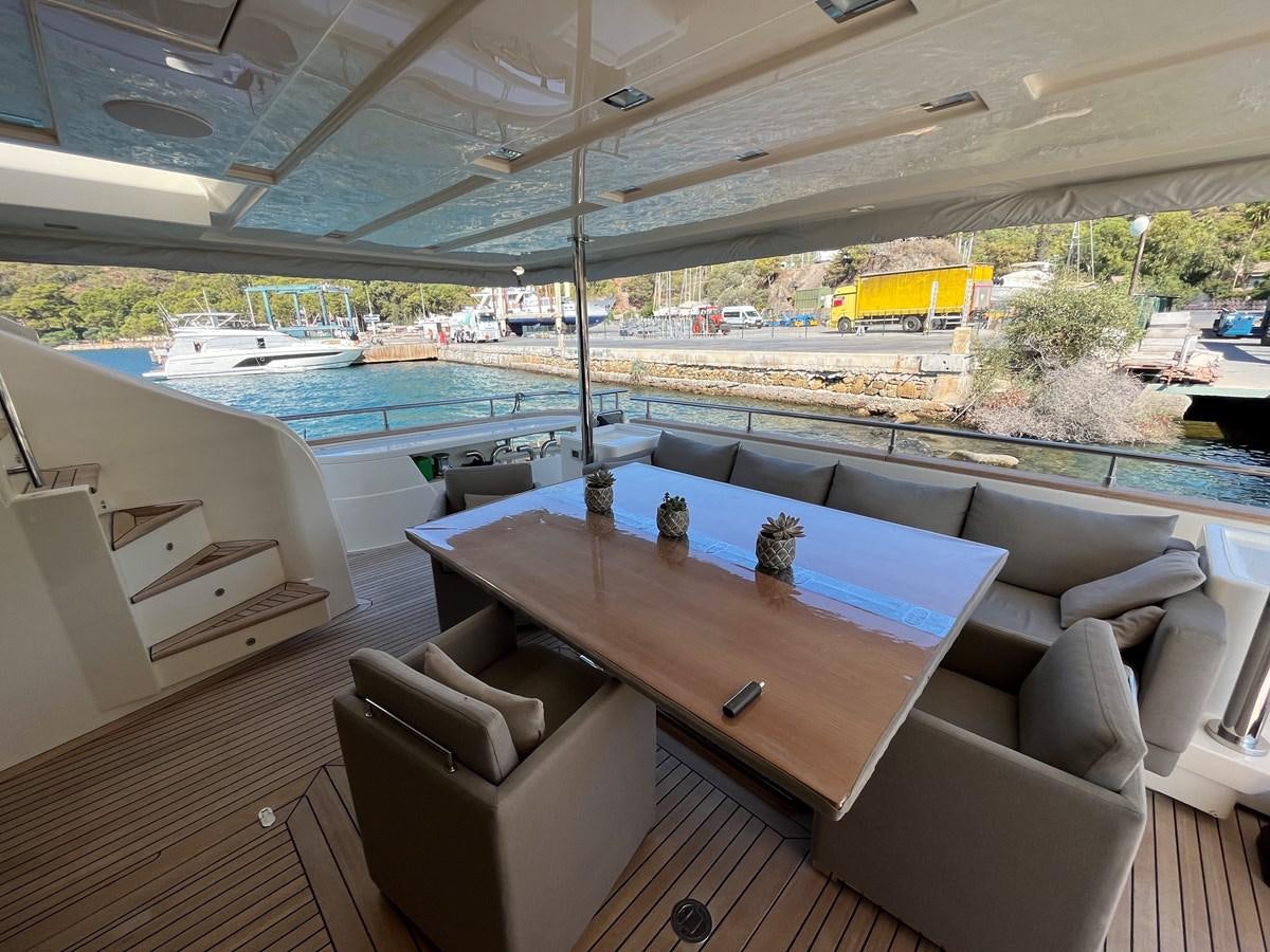 a room with a table and chairs aboard SELF Yacht for Sale