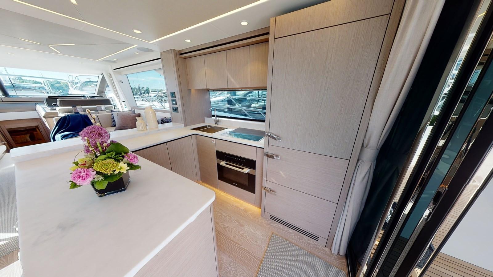 a kitchen with a table and chairs aboard RANI Yacht for Sale