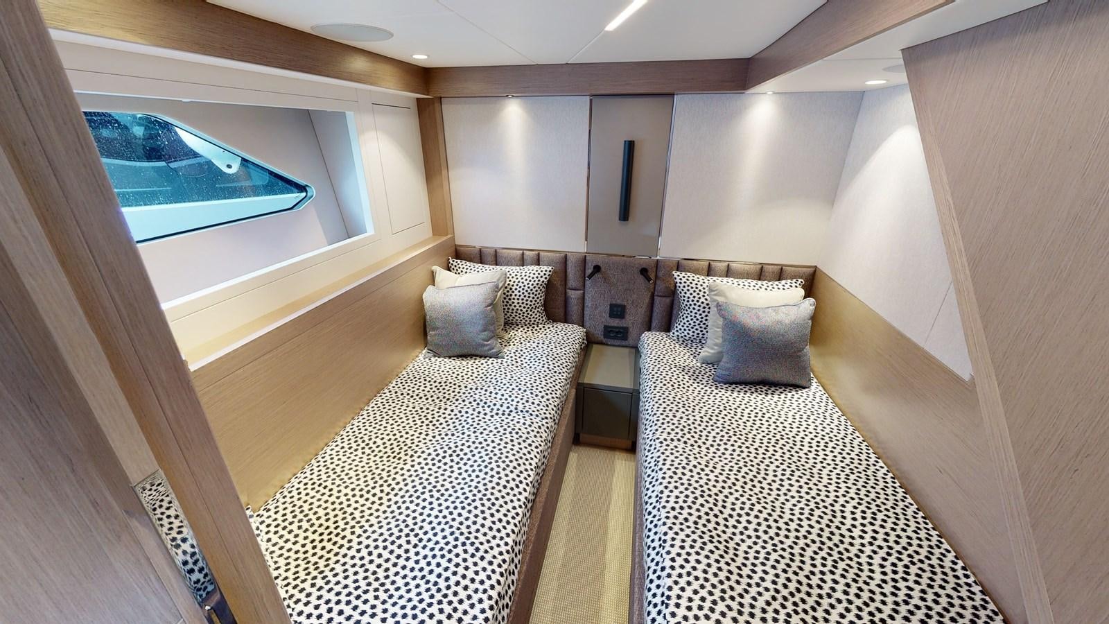 a bedroom with a bed and a window aboard RANI Yacht for Sale