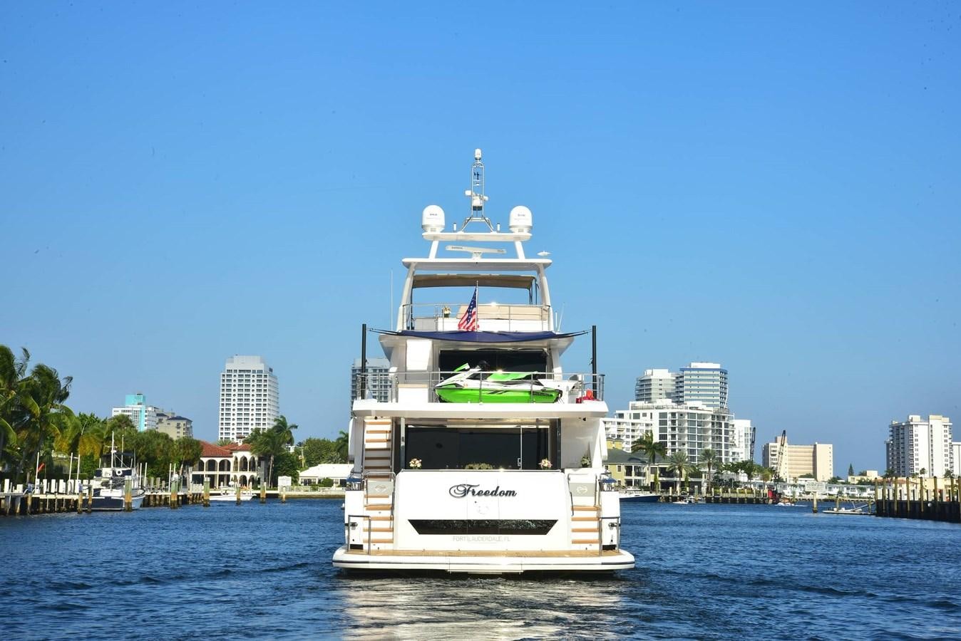 a large white boat on the water aboard FREEDOM Yacht for Sale