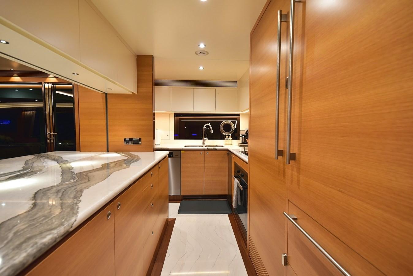 a kitchen with a large stainless steel refrigerator aboard FREEDOM Yacht for Sale