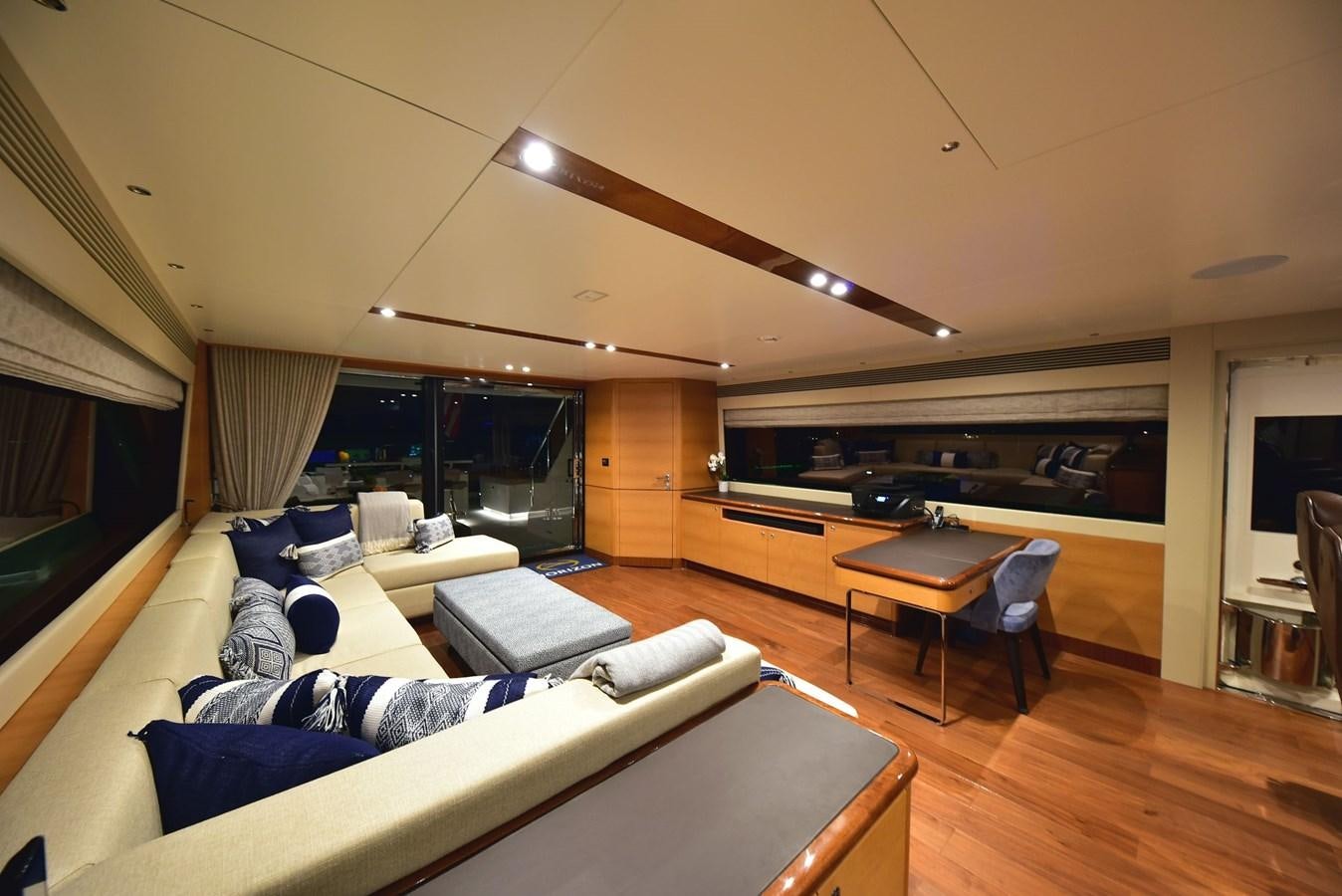 a living room with a large screen aboard FREEDOM Yacht for Sale