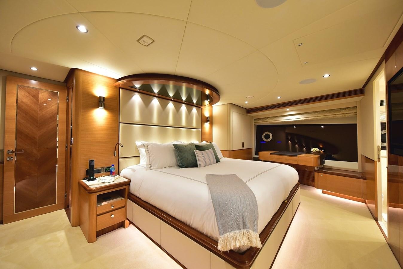 a large bedroom with a large mirror aboard FREEDOM Yacht for Sale