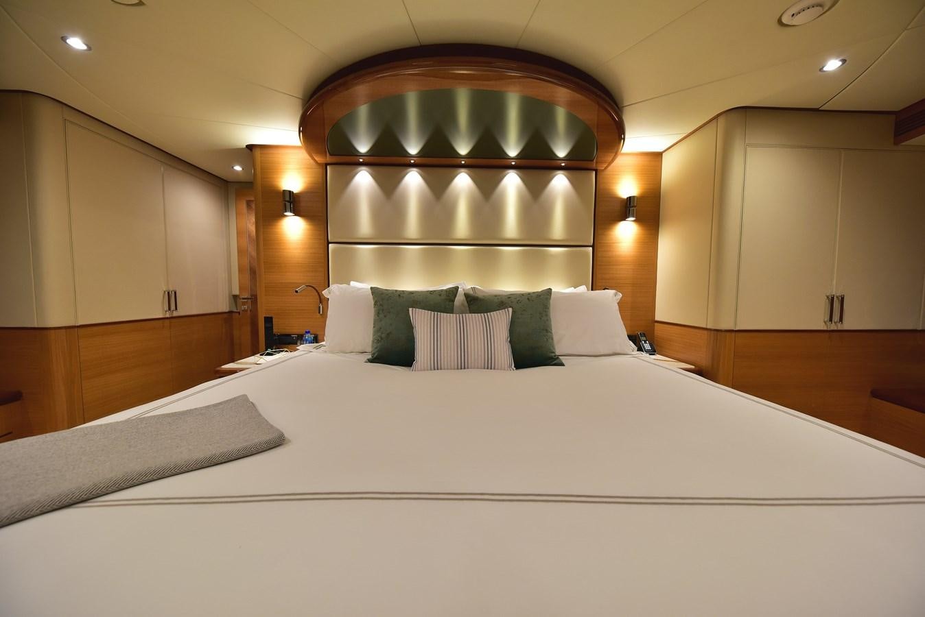 a large bed with white sheets aboard FREEDOM Yacht for Sale