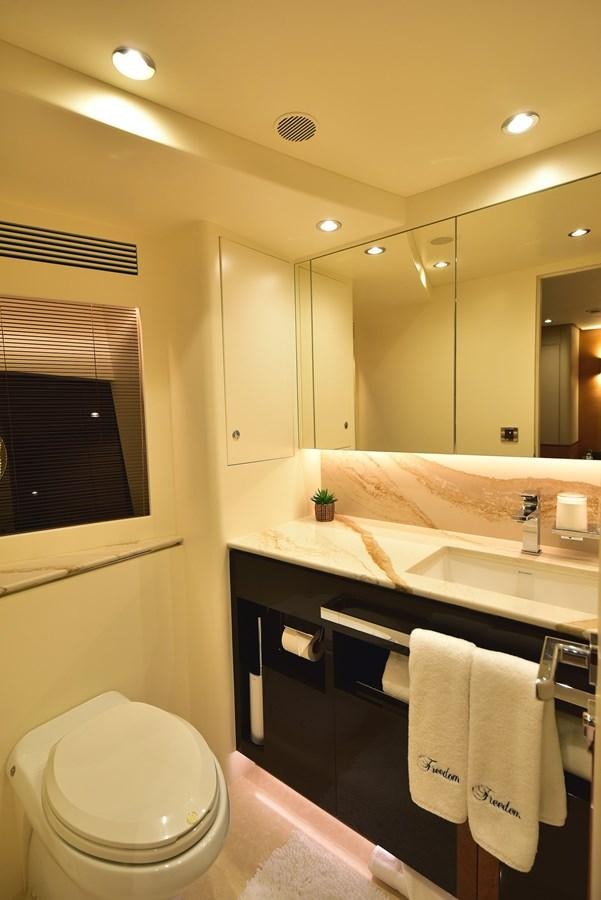 a bathroom with a toilet and a sink aboard FREEDOM Yacht for Sale