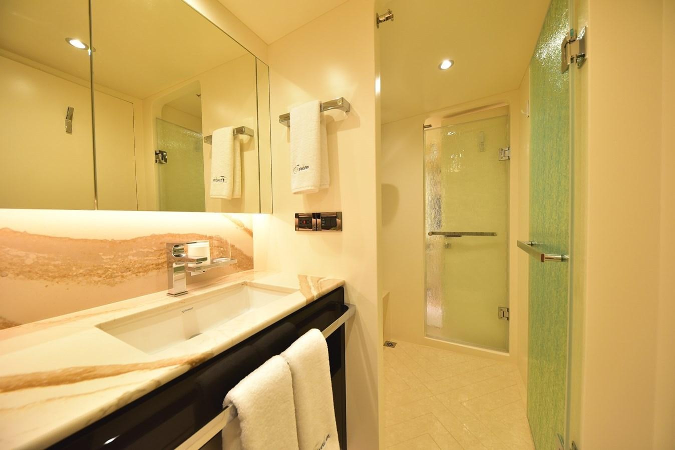 a bathroom with a glass shower door aboard FREEDOM Yacht for Sale