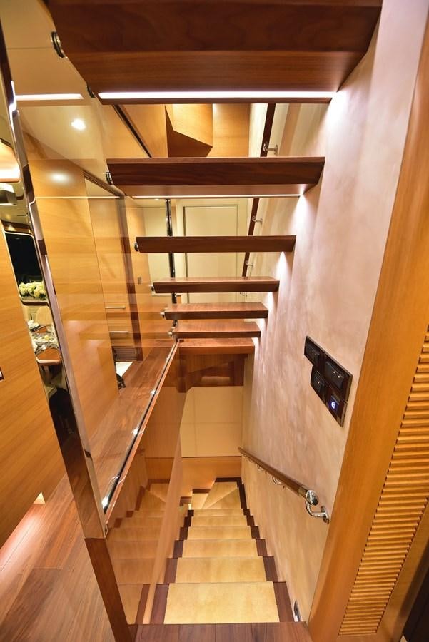 a wooden staircase in a house aboard FREEDOM Yacht for Sale