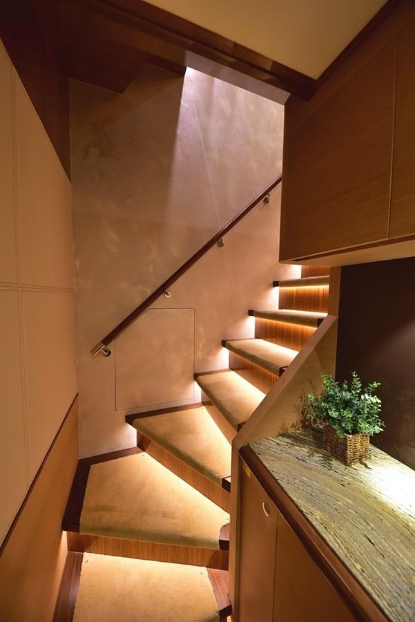 a staircase with a plant on the side aboard FREEDOM Yacht for Sale