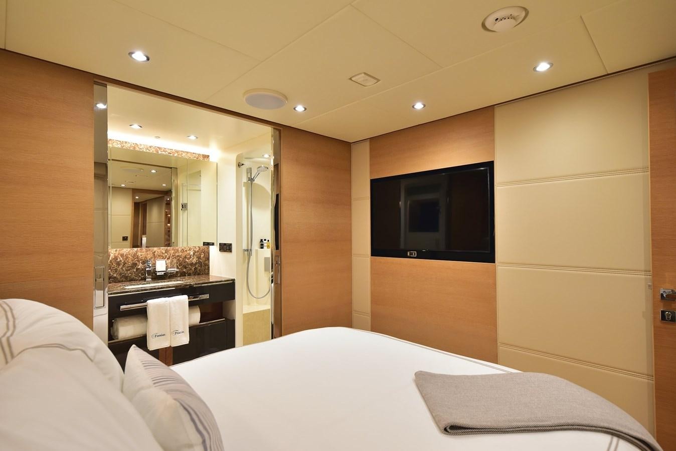 a hotel room with a bed and tv aboard FREEDOM Yacht for Sale