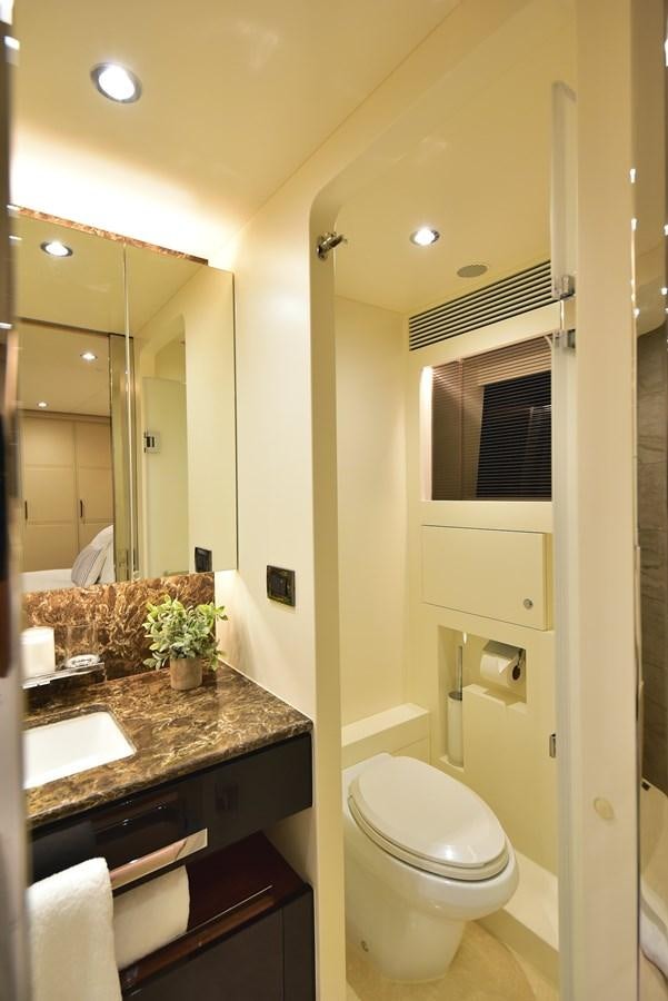 a bathroom with a toilet and a sink aboard FREEDOM Yacht for Sale