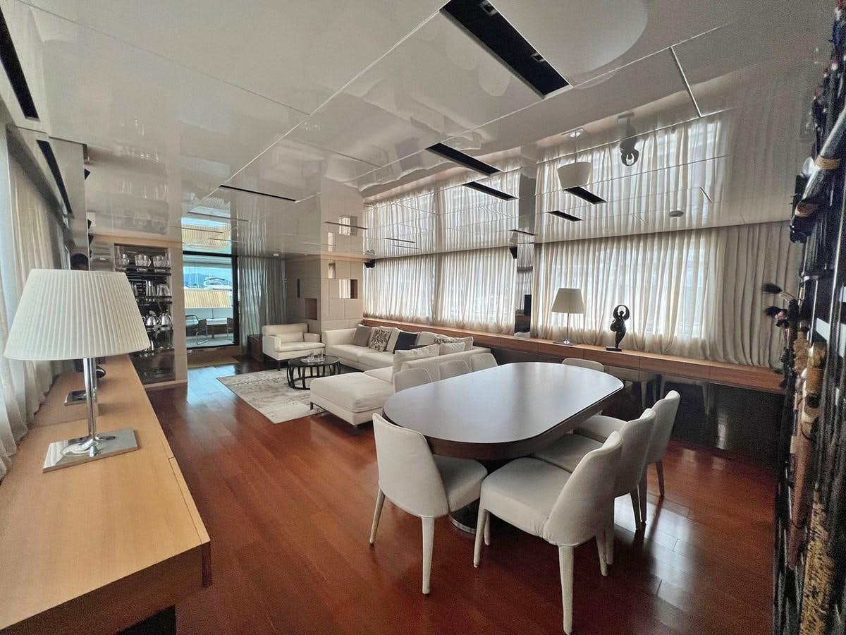 a room with a bed and a table aboard INDIGO Yacht for Sale