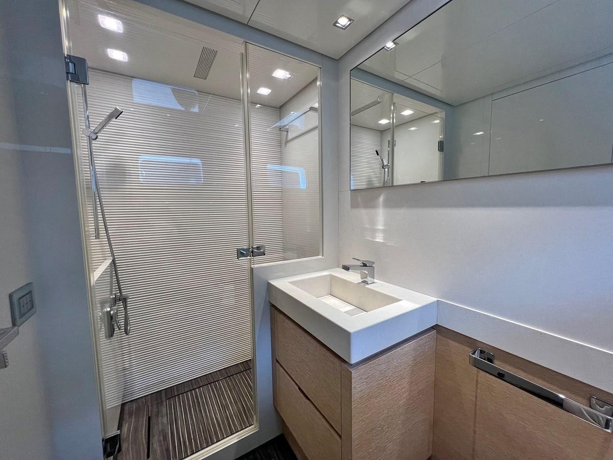 a bathroom with a glass shower aboard INDIGO Yacht for Sale