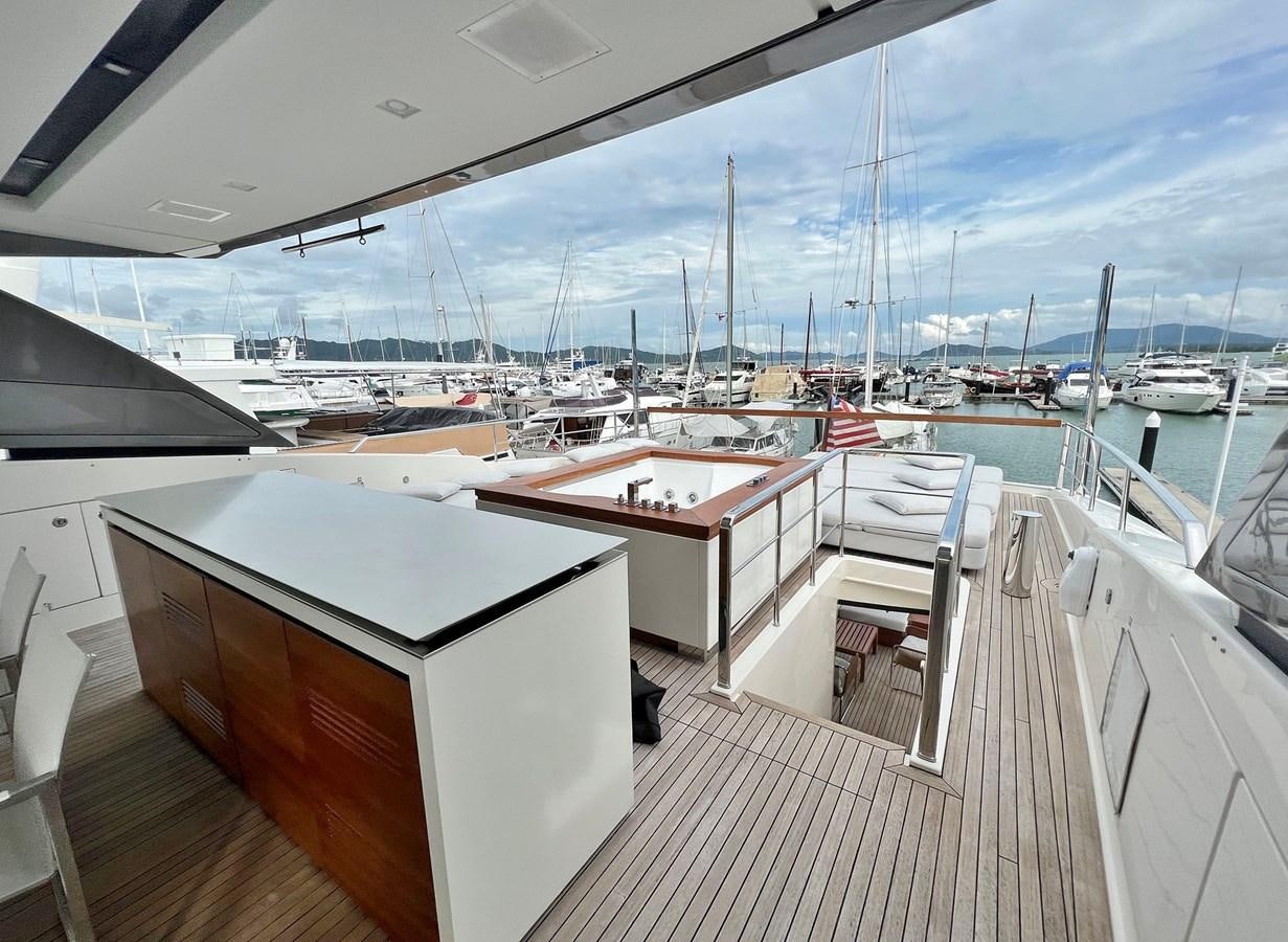 a deck with a view of a marina and boats aboard INDIGO Yacht for Sale