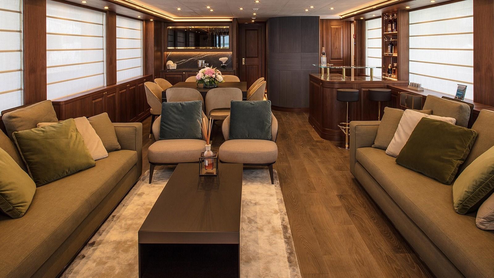 a living room with couches and a coffee table aboard ATLAS Yacht for Sale