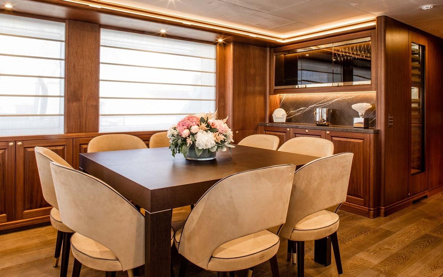 a dining table in a room aboard ATLAS Yacht for Sale