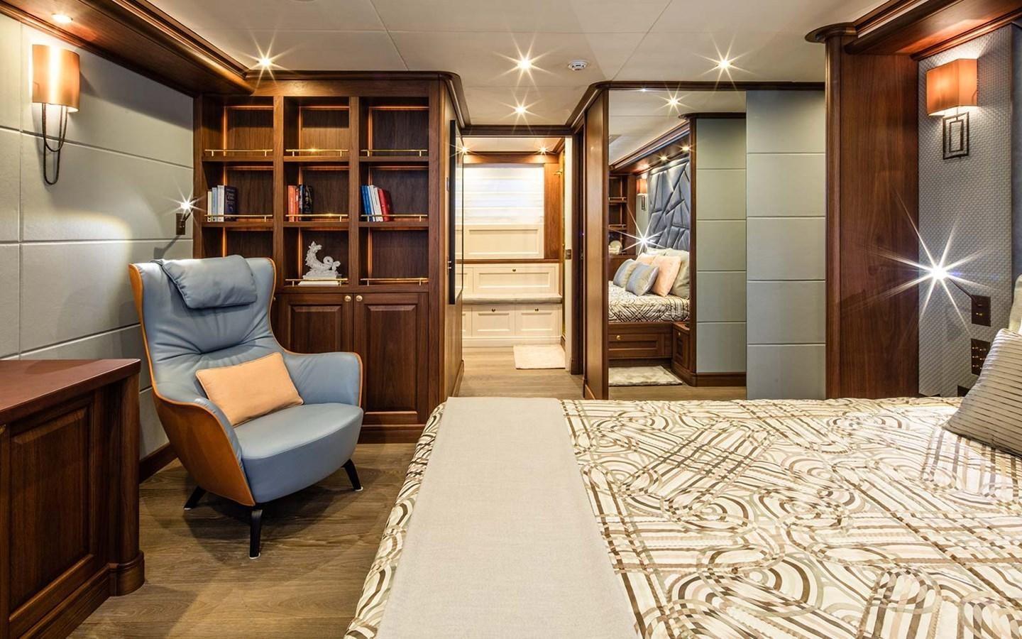 a room with a bed and a chair aboard ATLAS Yacht for Sale