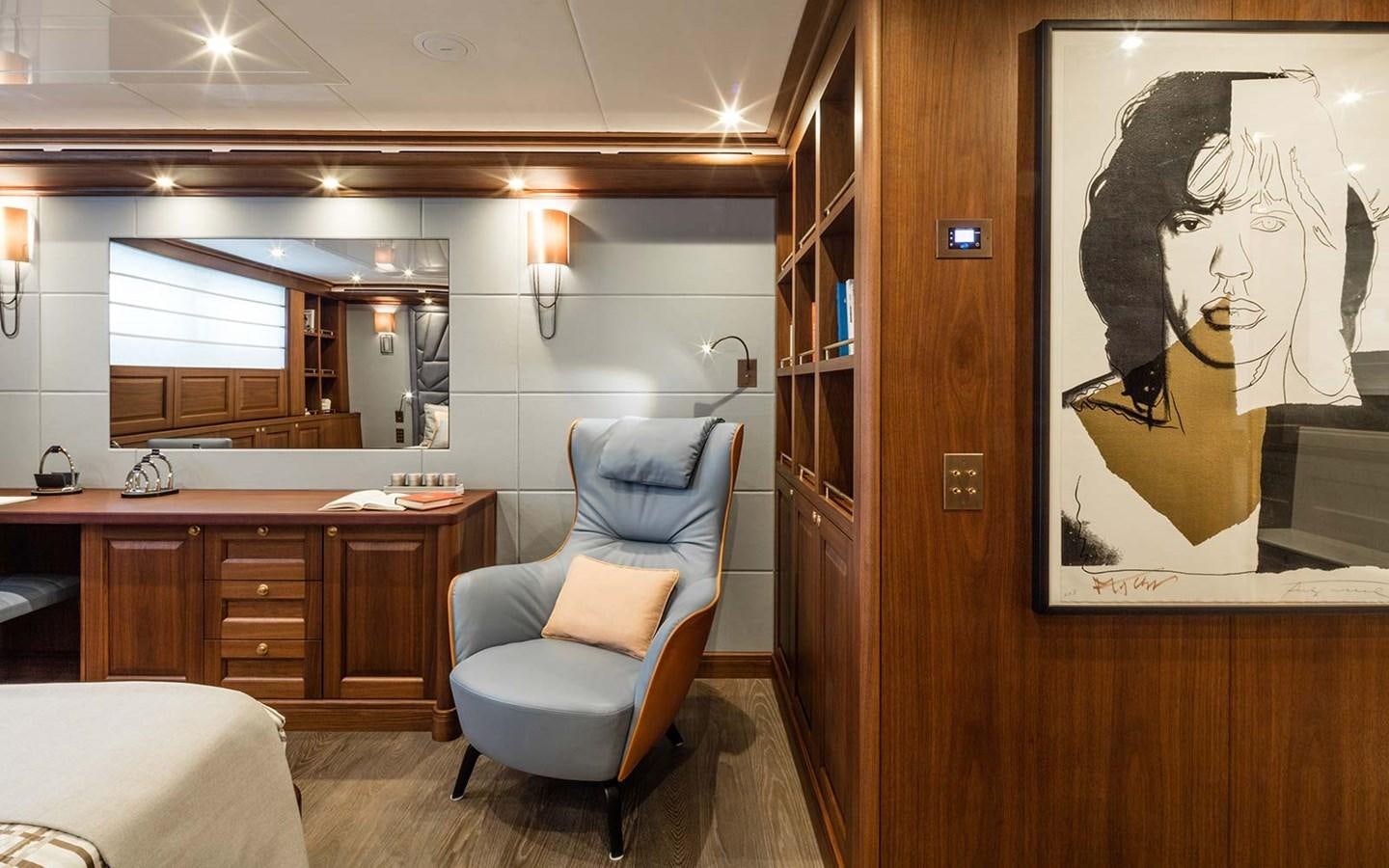 a room with a chair and a painting on the wall aboard ATLAS Yacht for Sale