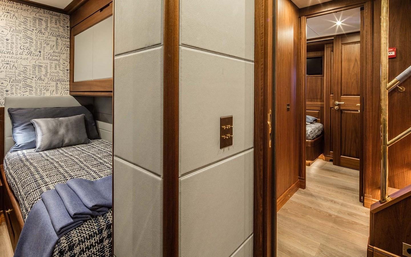 a bedroom with a bed and closet aboard ATLAS Yacht for Sale