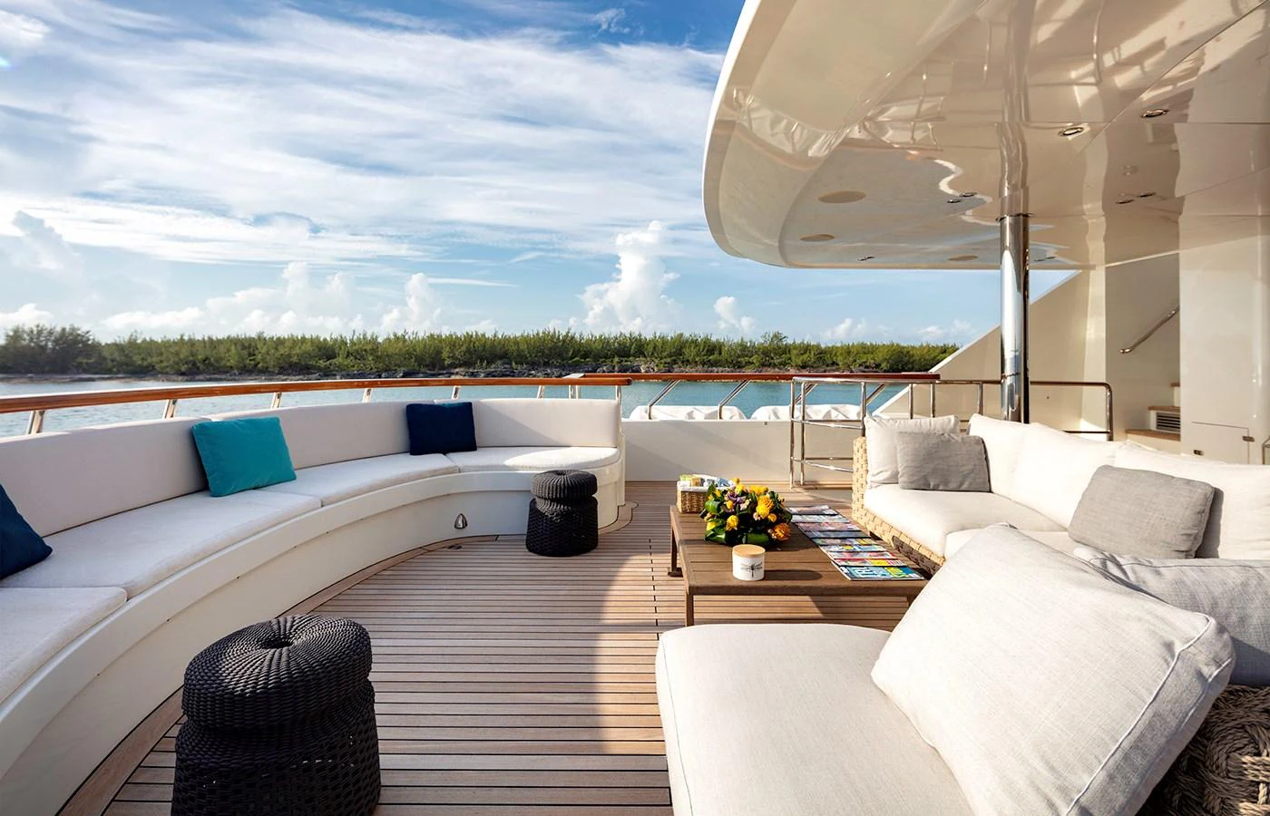 a living room with a large white couch and a large window aboard MYSTIC Yacht for Charter