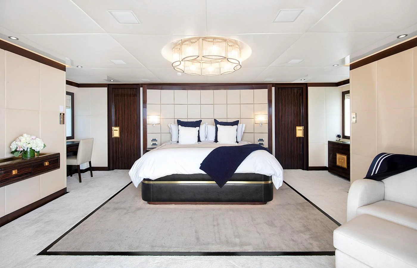 a large bedroom with a bed and a desk aboard MYSTIC Yacht for Charter