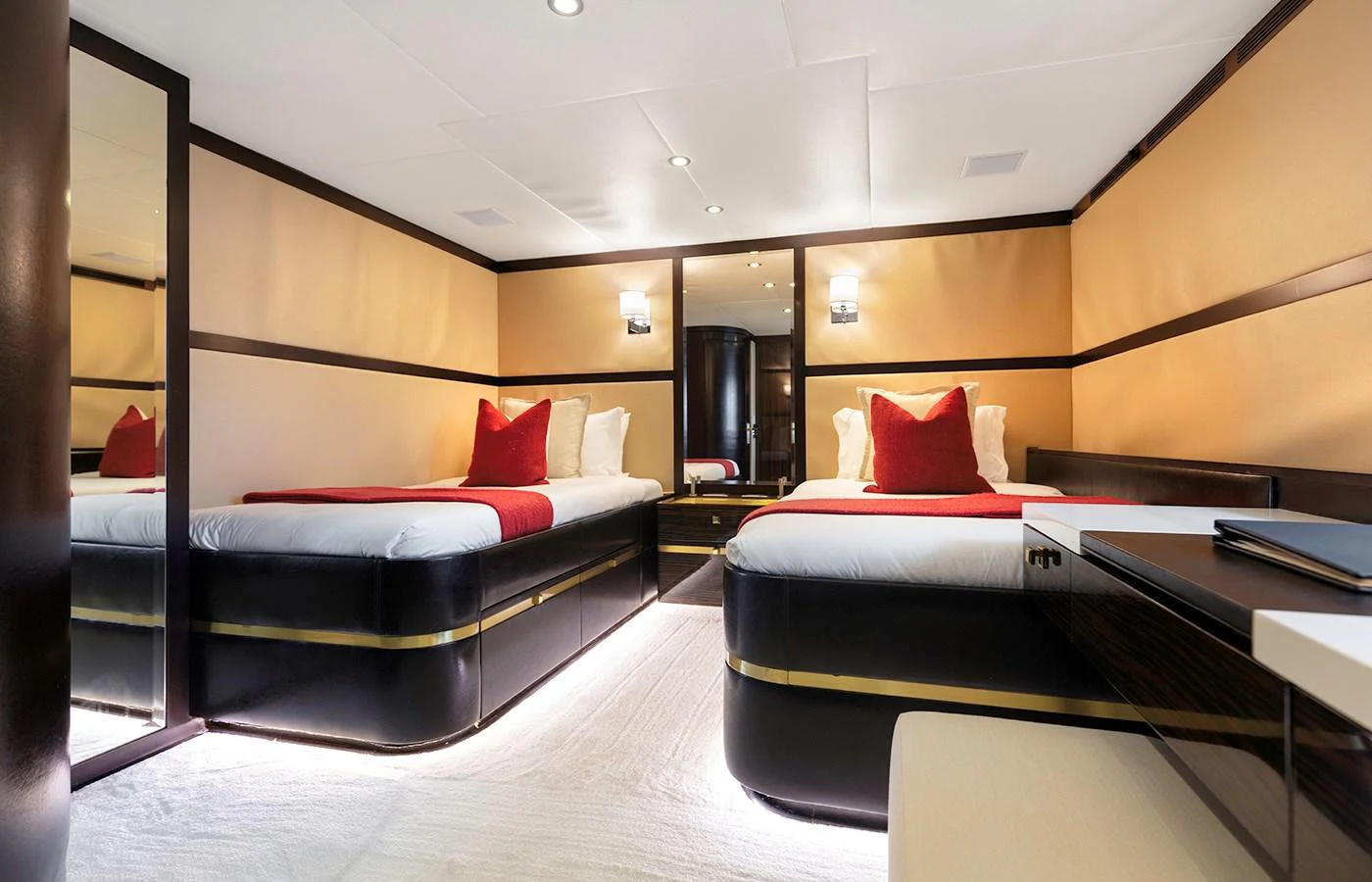 a room with a bed and desk aboard MYSTIC Yacht for Charter